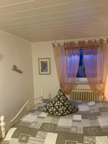 a bedroom with a bed with purple curtains and a window at Lilo Luisa in Weinheim