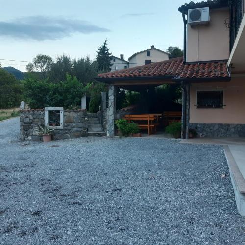 a house with a gravel yard next to a building at APARTMA in SOBE PILIH in Vipava