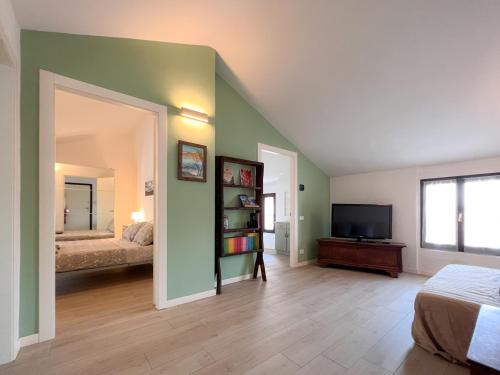 a bedroom with a bed and a television in it at Mansarda Montebello in Rovato