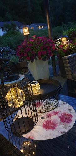 a bird cage sitting on top of a table with flowers at Dalen Studio 1 in Dalen