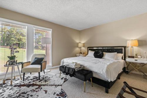 a bedroom with a bed and a desk and a chair at Legends and Masters Iron Suite in Pinehurst