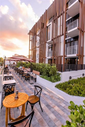 a patio with tables and chairs on a building at Upsun Hotel in Miami Beach