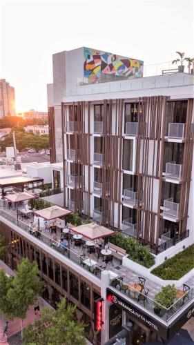 an overhead view of a building with a patio and tables at Upsun Hotel in Miami Beach