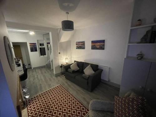 a living room with a couch and a rug at Two bed holiday home in Conwy in Conwy
