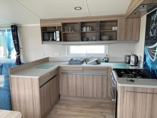 an rv kitchen with a sink and a stove at Blackpool caravans Marton mere in Blackpool