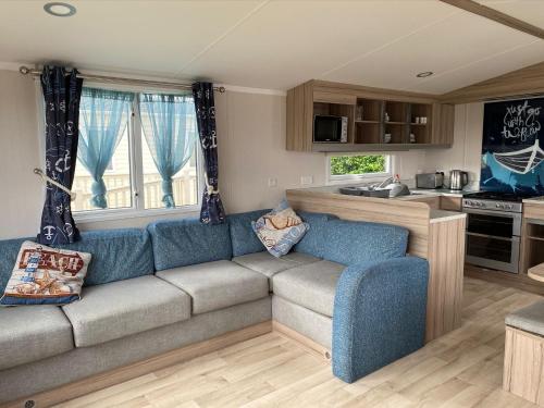 a living room with a couch and a kitchen at Blackpool caravans Marton mere in Blackpool