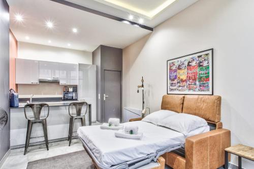 une chambre avec un lit et une cuisine dans l'établissement Studio Rambuteau - Welkeys, à Paris