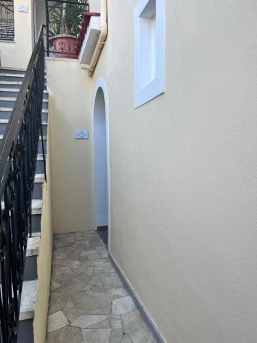 a hallway of a building with stairs and a window at ERIDA Accommodation in Lákka