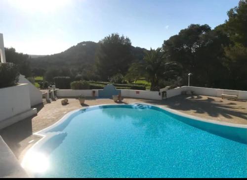 a large blue swimming pool on the side of a house at FLAT Surrounded by Nature WIFI & Pool & beach Nearby in Son Parc