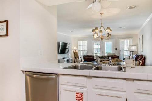 a kitchen with a sink and a living room at 5 C, Three Bedroom Townhome in Destin