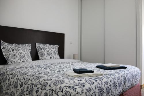 1 dormitorio con 1 cama con 2 toallas en Casa dos Remendos - Alojamento Local en Termas de Sao Pedro do Sul
