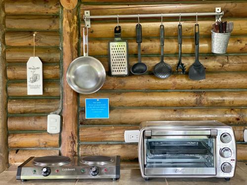 a kitchen with a toaster oven and cooking utensils at Horizon Hotel & Yoga Center in Santa Teresa Beach