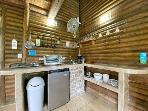 a kitchen with wooden walls and a counter top at Horizon Hotel & Yoga Center in Santa Teresa Beach