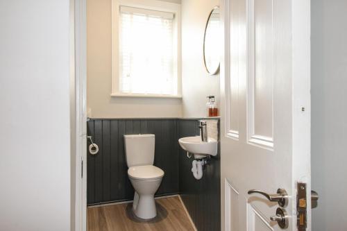 a bathroom with a toilet and a sink at Swanage Bay in Swanage