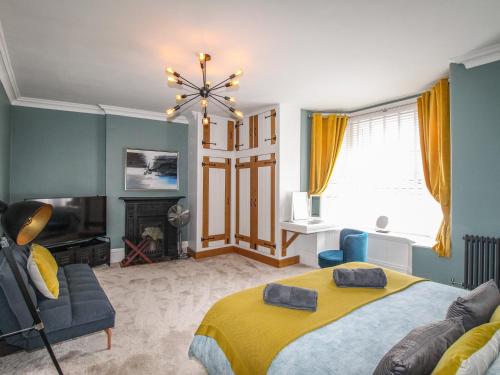 a bedroom with a bed and a couch and a window at Swanage Bay in Swanage