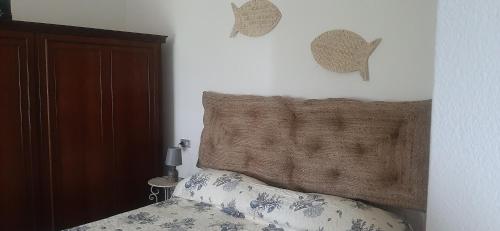 a bedroom with a bed with a wooden head board at CA DU STEA in Lavagna