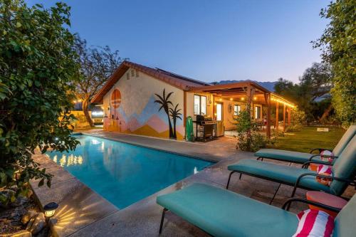 a house with a swimming pool next to a building at Poolside Palm Springs Paradise in Palm Springs