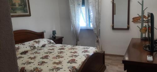 a bedroom with a bed with a comforter on it at CA DU STEA in Lavagna