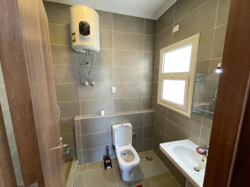 a bathroom with a toilet and a sink at Amwaj Seaside Retreat- Luxury 2BR Chalet in Amwaj Sidi Abdelrahman in El Alamein
