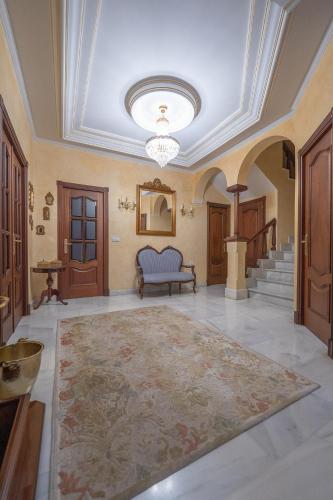 an ornate living room with a ceiling and a rug at VILLA CAPITAN in Sanlúcar de Barrameda