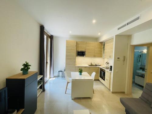 a kitchen and a living room with a table and chairs at NICE CENTRIC APARTMENT in Vilanova i la Geltrú