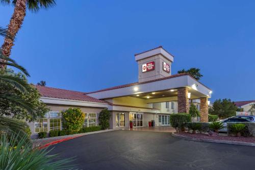 a hotel with a clock tower in a parking lot at Best Western Plus Las Vegas West in Las Vegas