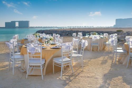 a table set up for a wedding on the beach at Radisson Resort Ras Al Khaimah Marjan Island in Ras al Khaimah