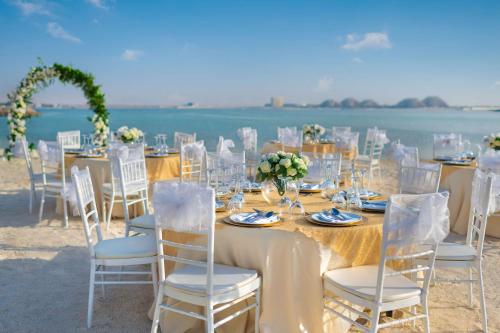 a table set up for a wedding on the beach at Radisson Resort Ras Al Khaimah Marjan Island in Ras al Khaimah