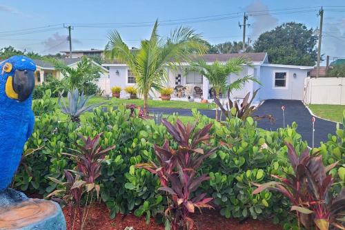 a blue bird statue in front of a house at Palm Springs 3-Bedroom 2-Bath 5 Miles to the Beach in Lake Worth
