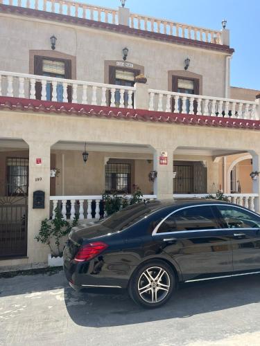 a black car parked in front of a house at La Marina Urb, Beautiful 4 bedroom House, Alicante, San Fulgencio, Spain in La Marina