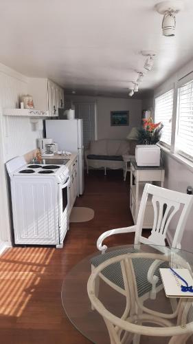 a kitchen with a table, chairs and a refrigerator at Bungalow Beach Resort in Bradenton Beach
