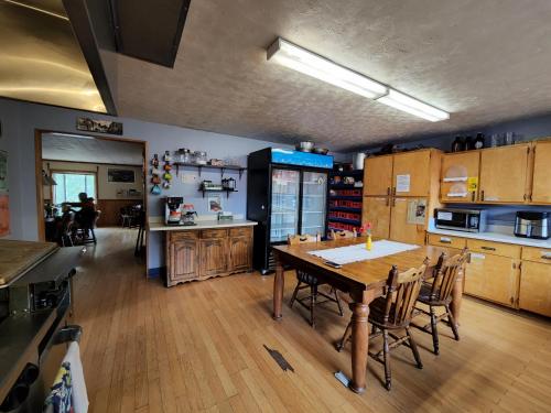 une grande cuisine avec une table et des chaises en bois dans l'établissement Inn the Clouds Hostel & Inn, à Leadville