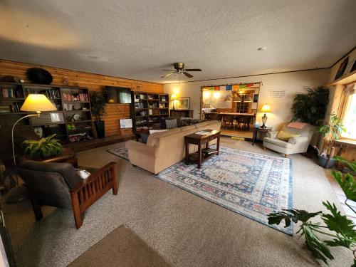 a living room with a couch and a table at Inn the Clouds Hostel & Inn in Leadville