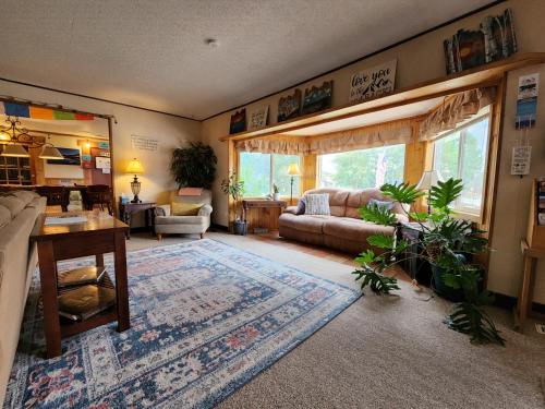 a living room with a couch and a table at Inn the Clouds Hostel & Inn in Leadville