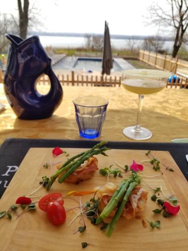 a wooden table with food and a glass of wine at La maison de l'île d'Orléans -- déjeuner gastronomique à l'aveugle in Saint-Jean
