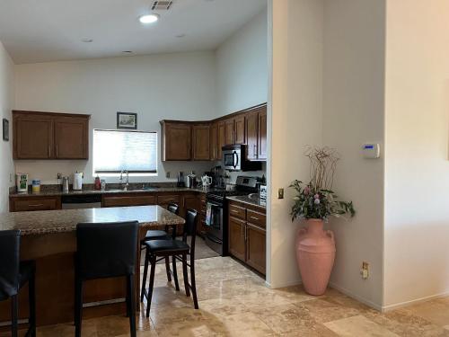a kitchen with wooden cabinets and a table with chairs at Miracle mineral water pool and spa in Desert Hot Springs