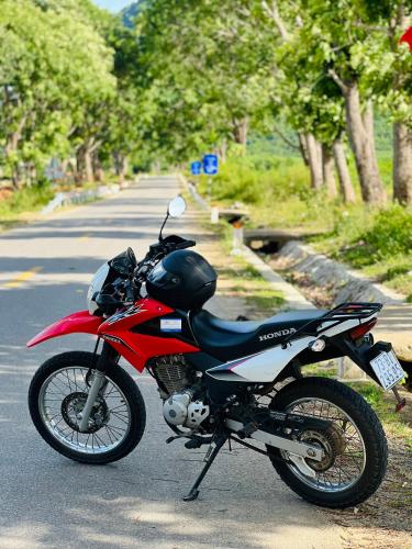 a red and black motorcycle parked on a street at HAI DANG HOTEL in Xóm Ðé
