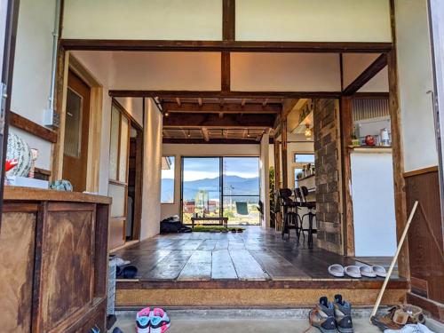 an open living room with a view of the ocean at Guest House Inawashiro~Hanbog~ in Inawashiro