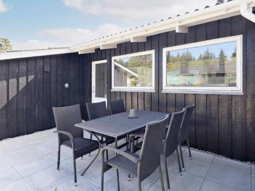 a black table and chairs on a patio at 10 person holiday home in Fjerritslev-By Traum in Fjerritslev