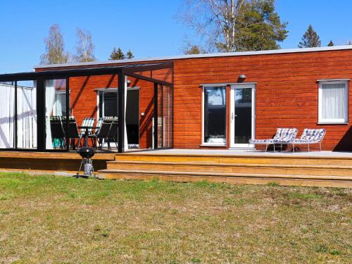 a home with a large deck with chairs on it at 6 person holiday home in SÄFFLE-By Traum in Säffle