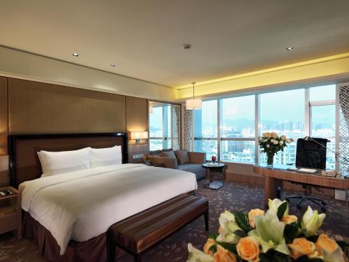 a hotel room with a bed and a large window at C&D Hotel Quanzhou in Quanzhou