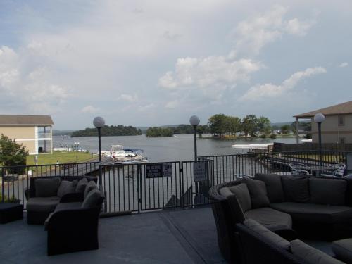 a balcony with couches and a view of a river at Baymont on the lake by Wyndham Hot Springs in Hot Springs