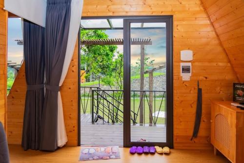 a room with a large glass door with a balcony at AKECHI 'S GARDEN - Venuestay in Hòa Bình