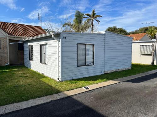 a small white house on the side of a street at Goin Coastal in Busselton