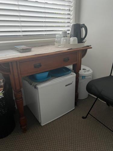 a wooden table with a desk on top of a computer desk at TAURANGA, Bay of Plenty in Tauranga