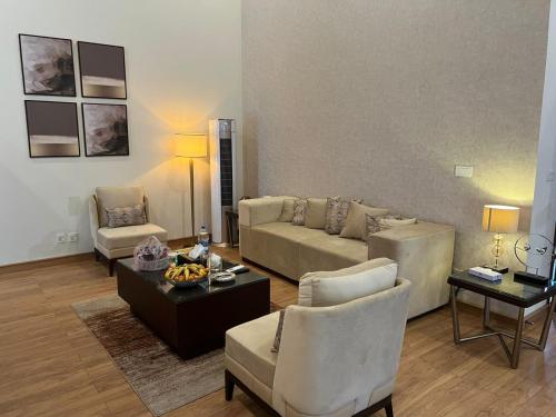 a living room with a couch and a table and chairs at Marco Polo Resort Kaghan in Kāgān