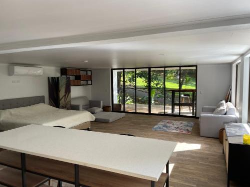 a room with a bed and a couch and a table at Loft Mágico en Nativa Resort in Tarcoles