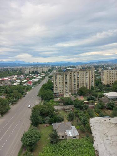 an aerial view of a city with buildings and a street at Panorama Kutaisi in Kutaisi