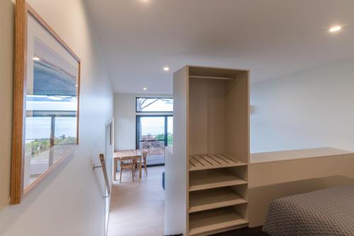 a bedroom with a bed and a walk in closet at Swansea Beach Chalets in Swansea