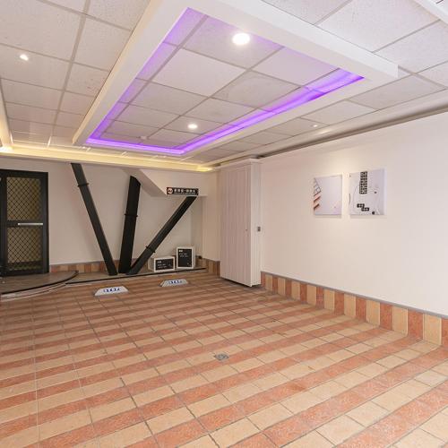 a large room with a purple light on the ceiling at Soho Motel in Taoyuan